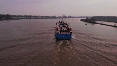 View-Of-Stern-Of-Wilson-Leith-Cargo-Ship-On-Oude-Maas-Heading-Into-Horizon