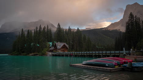 Time-Lapse,-Serene-Landscape-of-Yoho-National-Park,-Emerald-Lake-Lodge,-Canoes,-Road-and-Clouds-Moving-Above-Mountain-Peaks