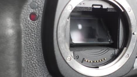 Hand-Taking-Off-Body-Cap-From-Sensor-On-DSLR