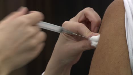 Isolated-view-of-a-person's-arm-being-injected-with-the-COVID-vaccine