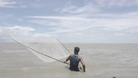 Wide-shot-of-a-Bangladeshi-fisherman-fishing-in-the-river-during-the-flood