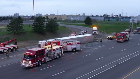 Semi-truck-flipped-on-side-at-end-of-interchange,-highway-accident