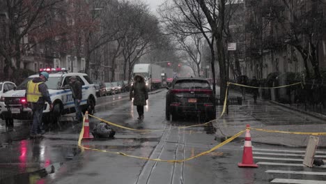 ConEdison-employee-Establishing-a-Perimeter-with-Traffic-cones,-under-a-snowfall-in-New-York---Wide-shot