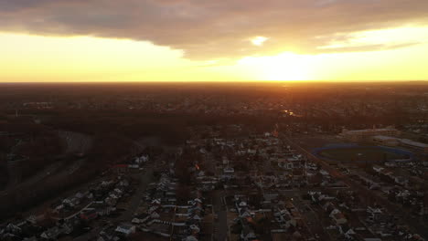 A-high-angle,-aerial-view-over-a-Long-Island-neighborhood-during-a-golden-sunrise