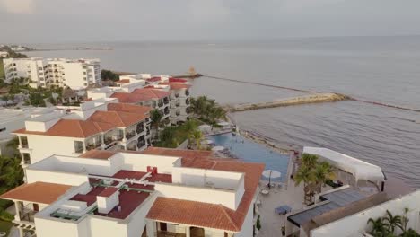 AERIAL---Hotel,-swimming-pools,-horizon-in-Cancun,-Mexico,-circle-shot