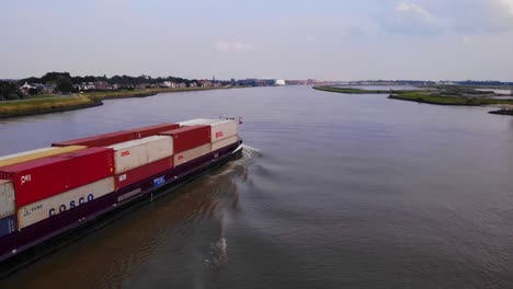 Aerial-Starboard-View-Of-En-Avant-Cargo-Ship-Going-Past-On-Oude-Maas