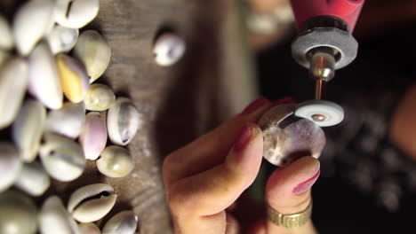 Close-up-gimbal-shot-of-female-hands-shaping-seashell