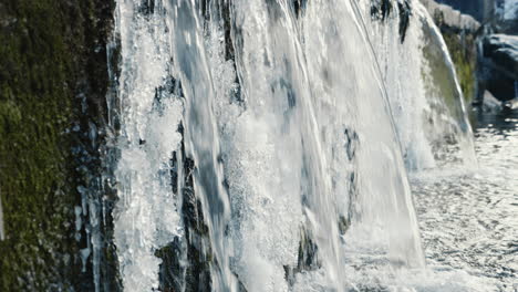 multiple-waterfalls-in-the-frozen-river,-traveling-medium-shot,-slow-motion