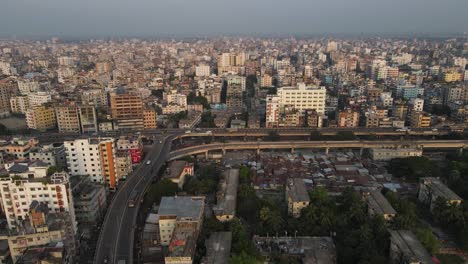 Aerial-drone-shot-of-Dhaka-showing-flyover-and-traffic-with-densely-populated-city-buildings