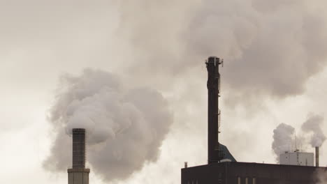 ZOOM-OUT---Factory-chimneys-with-copy-space-billowing-out-smoke