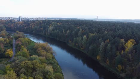 AERIAL-Orbiting-Shot-of-Vingis-Park-in-Vilnius-with-Autumn-Foliage-in-October