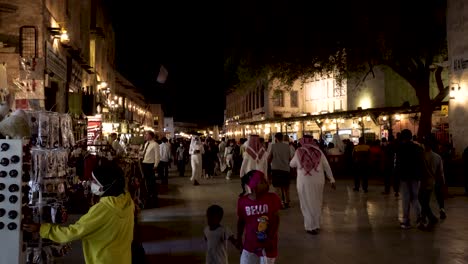 Nighttime-view-of-the-central-souk-in-Doha,-Qatar-with-local-people-and-tourists-shopping-in-the-COVID-era
