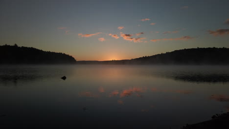Magic-hour-wide-shot-showing-mist-rising-from-MacDonald-Lake-and-sky-reflected-on-the-water