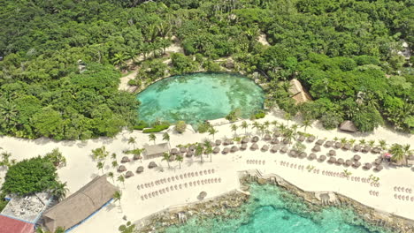Cozumel-Mexico-Aerial-v15-birds-eye-view-capturing-private-seaside-amusement-park,-vertical-straight-down-overlooking-at-the-lagoon-and-surrounding-natures---September-2020