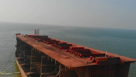 Aerial-Over-Large-Dismantled-Ship-With-Open-Hatches-At-Gadani,-Pakistan
