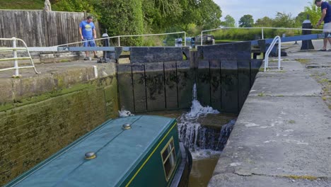 Men-opening-sluice-gates-to-flood-lock-for-navigating-narrowboat-along-Shropshire-Union-canal
