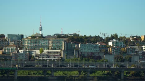 Establishing-shot-of-traffic-along-the-Gangbyeonbuk-expressway,-in-Yongsan-gu-district-in-Seoul,-South-Korea-aand-view-of-the-Namsan-Tower