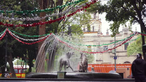 A-pair-of-bronze-coyote-statues-in-a-Coyoacan-park,-Mexico-City