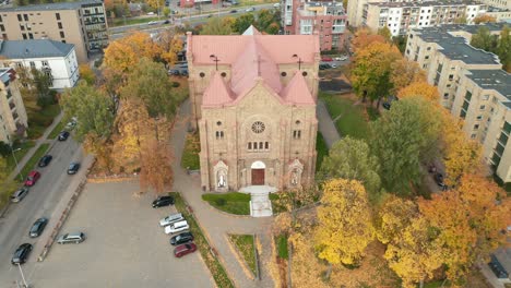 AERIAL:-Church-in-Zverynas-Suburb-in-Vilnius-During-Autumn-on-a-Cloudy-Day