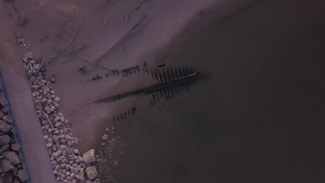 Rising-rotating-aerial-of-shipwreck-The-Contest-on-beach-in-Michigan