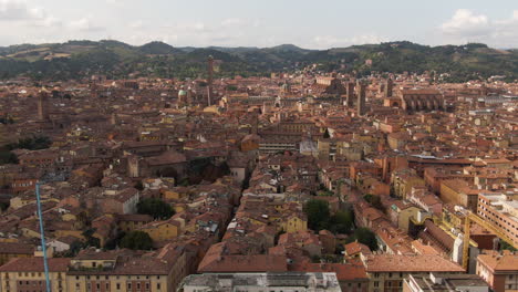 Cinematic-view-of-Bologna-city-old-town,-side-flying-ascend-drone-view