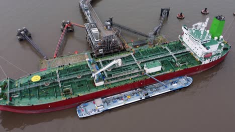 Silver-Rotterdam-oil-petrochemical-shipping-tanker-loading-at-Tranmere-terminal-Liverpool-aerial-top-view-zooming-in