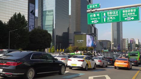 Heavy-Traffic-Near-Coex---Taxi,-Cars,-Buses-Stopped-on-Red-Sign-Waiting-for-Green-Traffic-Light-on-Yeongdong-daero-Road-Near-Coex-World-Trade-Center-Seoul,-South-Korea,-Trade-tower,-STtown-Artium