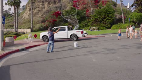 Older-man-making-giant-bubbles-for-kids-at-the-end-of-a-street