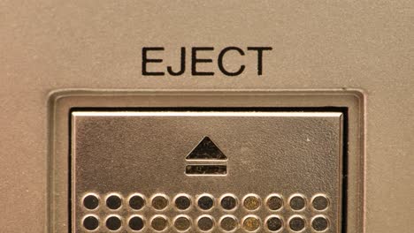 Extreme-close-up-of-buttons-on-an-old-antique-or-vintage-VCR-pushing-the-eject-button