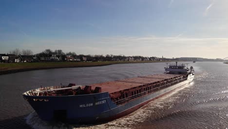 Aerial-Drone-View-Of-Wilson-Mersey-Navigating-River-Noord-On-Clear-Sunny-Day