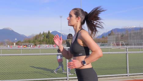 Attractive-athletic-young-woman-running-slow-motion-tracking-shot