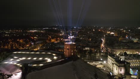Vilnius-Gediminas-Tower-with-Lasers-Beams-Lightning-the-Sky-on-Late-Winter-Evening
