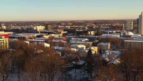Drone-shot-over-snowy-roof-tops-of-Karlova-district-towards-to-Snail-tower-Tigu-torn