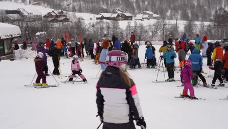 Mikkel-character-from-Mikkelparken-Norway-is-skiing-together-with-children---fun-time-outdoor-skiing-with-costume---Smooth-handheld-panning-right