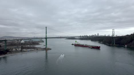 Cargo-ship-passing-under-Lions-Gate-Bridge,-Vancouver-in-Canada