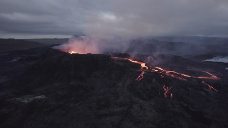 Aerial-view-around-magma-coming-out-from-a-crater-hole-in-the-earth-surface---tracking,-drone-shot