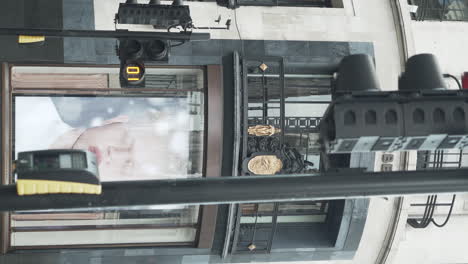 Vertical-shot-of-burberry-street-of-London-with-people-passing-by-and-heritage-building-in-the-background