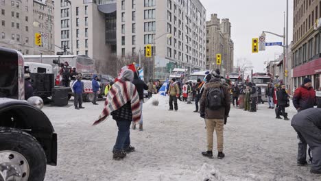 2022-Freedom-Convoy-Trucker-Protest-Downtown-Ottawa-Ontario-Canada-Anti-Mask-Anti-Vax-Mandates-COVID-19-Protestors-Playing-Soccer-in-Snow-at-Rideau