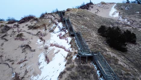 4K-Drone-of-stairway-in-a-sand-dune-on-the-lake-shore-of-l