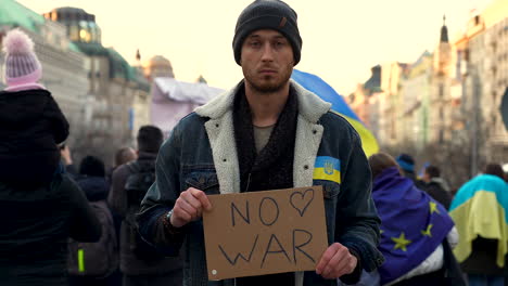 Protester-against-war-in-Ukraine-with-signboard,-Prague,-slow-motion