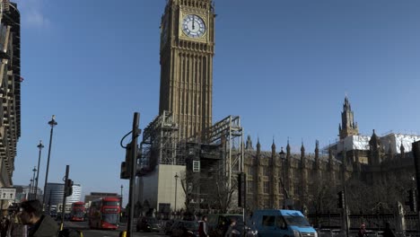 The-iconic-landmark-Big-Ben-strikes-noon-in-Westminster-London,-the-spectacular-clock-tower-looking-beautiful-as-the-scaffolding-from-its-recent-restoration-project-is-removed,-England