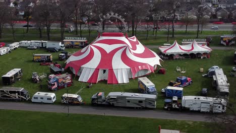 Planet-circus-daredevil-entertainment-colourful-swirl-tent-and-caravan-trailer-ring-aerial-view-orbit-right