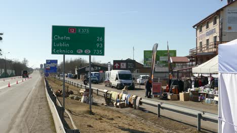 Polish-Ukrainian-border-Crossing,-humanitarian-aid-tents-on-road-side,-Refugee-Camp