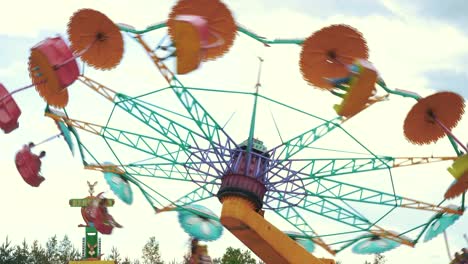 Ledmane-Parish,-Latvia---May-30,-2021:-Happy-People-Riding-on-Spinning-Swing-Carousel-in-Amusement-Park-and-Having-Fun