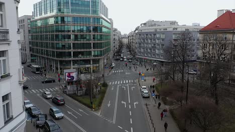 Aerial-drone-view-over-a-urban-street-in-Warsaw,-overcast-spring-day-in-Poland