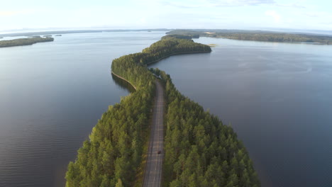 Car-driving-a-unique-road-going-through-islands-in-the-middle-of-a-lake-at-Pulkkilanharju-in-Finland