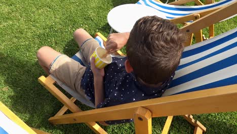 A-young-boy-eating-ice-cream-then-turns-to-see-if-anyone-is-watching