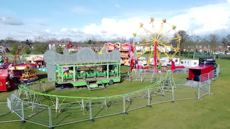 Small-town-vintage-fairground-Easter-holidays-funfair-rides-in-public-park-aerial-view