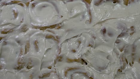Overhead-view-of-a-pan-of-freshly-baked-cinnamon-rolls-with-cream-cheese-icing