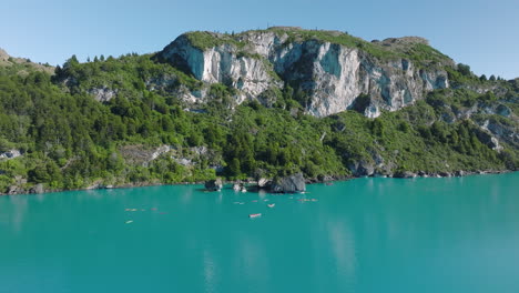 Aerial-Flying-Over-Turquoise-Lake-General-Carrera-Towards-Capillas-de-Marmol-With-Kayakers-Nearby